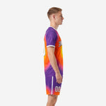 Custom purple orange gradient soccer uniform kit, left side view showing sleeve and shorts detail on male model