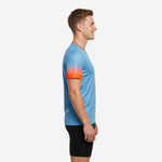 Custom v neck soccer training jersey in sky blue and orange gradient sleeve detail, left side view on male model