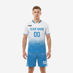 Vivid blue and white custom soccer uniforms front view showing dot-burst gradient jersey and matching sky blue shorts with player number