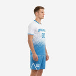 Blue and white custom soccer uniform left side view displaying dot-burst scatter pattern transitioning from white chest to sky blue hem