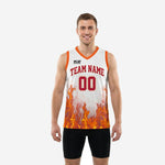 Custom white and orange basketball jersey with flame graphic on front, orange V-neck binding, and red arched team name and number - front view