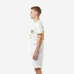 White and gold soccer uniform right side view with athletic gold trim on collar and sleeve cuffs