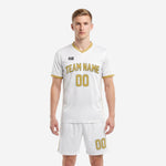 Custom white and gold soccer uniform front view, full kit with sublimated team name and number by K2 Sportswear