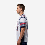 Left side view of white and navy sublimated football jersey showing stripe sleeve detail and shoulder panel seam