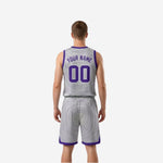 Silver-white reversible basketball jersey side view with purple trim at collar armholes and shorts hem