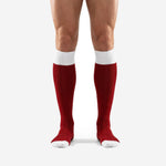 Front view of white trim custom red socks soccer in dark red with ribbed white cuff and white toe cap worn by male model