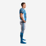 Light blue custom football uniform front view showing V-neck collar, navy sleeve band trim, white side panels, and front number placement on adult male model