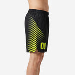 Side view of black and neon yellow custom basketball shorts showing full diagonal stripe sweep across the leg panel and side hem split