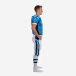Side view of blue and white youth football uniform showing navy shoulder panel, chevron pant stripe, and short set-in sleeve with white cuff binding