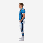 Close side view of youth american football team uniforms highlighting the diagonal navy and royal blue chevron panel running from hip to knee on white pants