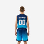 Opposite side view of youth basketball jersey and shorts set in navy and cyan gradient with contrast hem trim on shorts