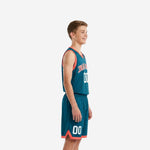 Front view of custom teal youth basketball uniform package with coral V-neck binding and arced team name across the chest