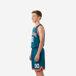 Side view of teal and coral youth basketball uniform showing sleeveless jersey and matching shorts with coral hem trim