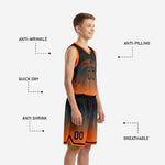 Opposite side view of personalized youth basketball uniforms in black and orange gradient showing shorts hem stripe and chevron accent detail