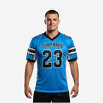 Youth football jersey personalized in electric blue with black stripe sleeve bands, team name arc and front number 23 on adult male model