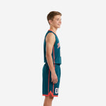Custom teal youth basketball uniform front view showing coral V-neck binding, arced team name across chest, and white front number with coral outline
