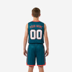 Opposite side view of teal youth league basketball uniform showing coral armhole binding, side accent stripe, and elastic waistband on shorts