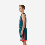 Side view of teal and coral youth basketball uniform showing coral vertical side stripe on jersey and matching stripe on shorts with V-notch hem trim