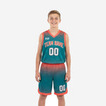 Front view of custom youth sublimated basketball uniforms in teal and orange halftone dot design, jersey and shorts set with team name and number 00