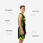 Close-up of black youth basketball shorts with neon lime hem binding, front number, and diagonal slash side panel sublimation detail