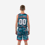 Back view of youth tournament basketball uniform in teal camo showing back number placement and orange hem binding on shorts