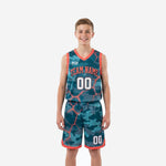 Youth tournament basketball uniforms in teal camo and orange lava-crack print, full jersey and shorts set shown from the front on a youth model