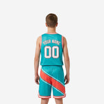 Opposite side view of teal and coral youth travel basketball uniform set showing pinstripe border detail and armhole binding