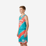 Side view of custom teal youth travel basketball uniforms showing diagonal stripe running from jersey shoulder through matching shorts panel