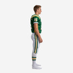 Side view of green and gold youth travel football uniform showing gold side panel on jersey and double stripe on white pants